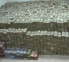 stacks of money sitting on top of each other in front of a white wall and floor