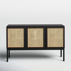 the sideboard is made out of black wood and has two doors with rattan panels