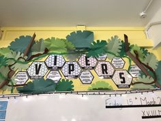 a bulletin board with trees and letters on it