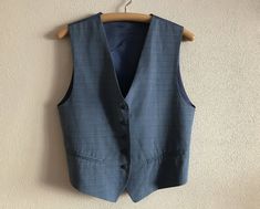 "Women's Vest Blue Womens Vest Blue Vest Formal Blue Linen Blend Women Waistcoat Edwardian Victorian Renaissance Steampunk Baroque  Label size: M Measurements (lying flat): Length(back): 20\"/ 51 cm Chest: 19.5\"/ 49.5 cm Waist: 18\"/ 46 cm Condition: great  Vintage Condition Material: 30%linen,30%polyester,40%viscose.Lining: 100%acetate N.B. Color may slightly differ from picture Please check measurements to insure a proper fit. Remember to allow yourself some extra room for movement. You can compare these with something from your closet that fits you well. SHIPPING * I ship worldwide via Priority mail  * Items are shipped 1 - 3 business days after receiving the payment. * I ship from Europe, so please allow 2 to 3 weeks for the package to arrive if you live overseas. * Europe 5 - 10 busi Formal Blue Vest With Buttons, Blue Fitted Vest For Fall, Fitted Blue Vest With Buttons, Elegant Blue Vest With Buttons, Blue Buttoned Vest For Fall, Blue Fitted Vintage Vest, Tailored Sleeveless Blue Vest, Blue Fitted Vest For Work, Fitted Blue Vest For Workwear