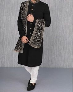 Item contains : Sherwani shawl and Pants  Fabrics :   Luxury suiting fabrics  Colours :  Black coat and white pants  Style and Designs :  Sherwani or Jacket- Suit has mandarin collar and long sleeves with a full button placket with asymmetrical hem and multiple slits and uneven bottoms come it's has red hand thread work over collar and sleeves  Shawl- Kashmiri embroidery velvet shawl Pants or Trousers  Cream coloured solid churidar has a drawstring closure with nara  Size :  Slim fit  Model heig Manyavar Sherwani For Groom, Manyavar Kurta Indian Weddings, Black Sherwani Men, Shaddi Dress, Black Cocktail Outfit, Manyavar Sherwani, Sherwani Black, Shawl For Men, Black Sherwani