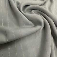 a close up view of a gray fabric with white pinstripe lines on it