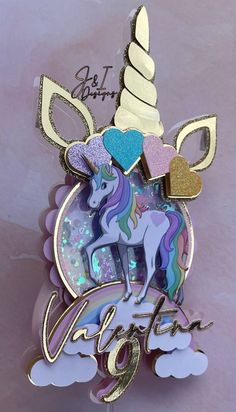 a unicorn brooch with glitters and hearts on it