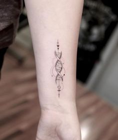 a woman's arm with a small tattoo on the left side of her wrist