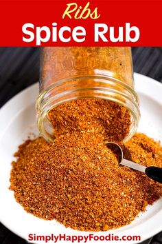 a jar filled with spices sitting on top of a white plate next to a spoon