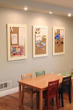 a dining room table and chairs with the words simple kids art display above it on the wall