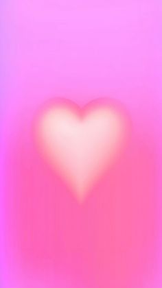 a blurry image of a heart in the middle of pink and blue colors with an overexposed background