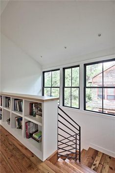 an empty room with bookshelves and stairs