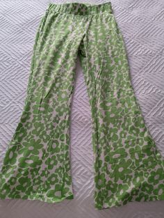 Fun hippy Shake trousers/ flares with elasticated waist. Super comfy! Green and white floral design.  Size medium UK 10/12 inside leg 62cm Full length 85 cm Excellent condition Patterned Cotton Bottoms With Floral Print, Floral Print Cotton Bottoms, Cotton Floral Print Patterned Bottoms, Patterned Floral Print Cotton Pants, Trendy Green Printed Pants, Hippie Style Flared Bottoms For Spring, Hippie Flare Bottoms For Spring, Casual Green Floral Print Pants, Green Bohemian Bottoms With Floral Print