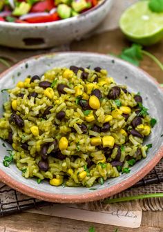 a bowl filled with rice and beans on top of a table