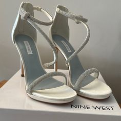 Add Some More Sparkle To Your Party Or Wedding Outfit With The Lavern Sandal By Nine West. This Stiletto Sandal Features A Thin Strappy Upper Styled With All Over Rhinestones And Asymmetrical Detail For An Eye-Catching Look, While Back Zipper Ensures Easy On/Off. Ivory/Off White Satin Shoes With .5” Platform, 4.25” Covered Stiletto Heel. Never Worn, Only Tried On Once. Satin Shoes, Bridal Heels, Stiletto Sandals, Nine West Shoes, White Satin, Stiletto Heel, On Off, Wedding Outfit, Nine West