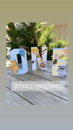 the letters are made out of paper and have winnie the pooh characters on them