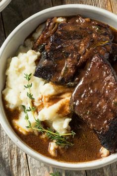 a white bowl filled with meat and mashed potatoes