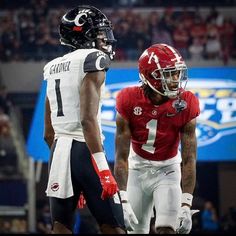 two football players standing next to each other