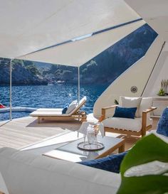 the inside of a boat with lounge chairs and an open area for sunbathers