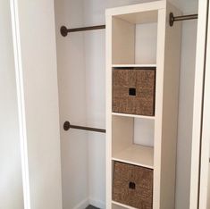 an empty closet with two baskets on the bottom shelf