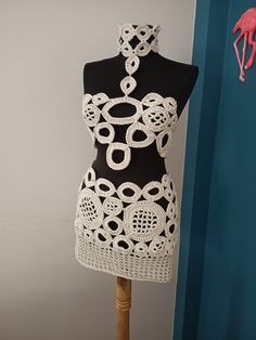 a mannequin is adorned with white crochet