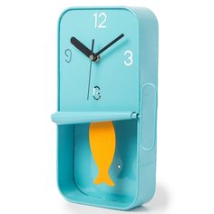 a blue clock with a yellow fish on the front and bottom part of it's face