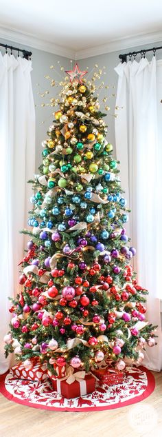 a christmas tree decorated with ornaments and ribbons