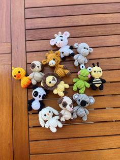 small crocheted animals sitting on top of a wooden table