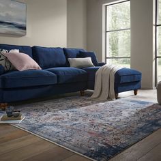 a living room with a blue couch and rug