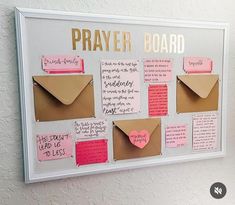 a bulletin board with sticky notes attached to it and a paper heart in the middle