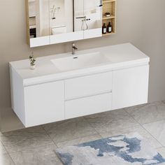 a bathroom vanity with two mirrors above it and a rug on the floor next to it