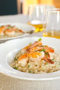 shrimp and rice in a white bowl on a table