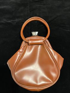 Vintage 60s funky brown vinyl handbag with lucite jeweled clasp.  Fabric lined interior.  Measures 9" x 9" and 1" wide. 70s Accessories Purse, Brown Evening Bag With Detachable Handle For Shopping, Modern Brown Evening Bag, Brown Shoulder Bag With Round Handle For Formal Events, Retro Leather Shoulder Bag For Party, Modern Brown Bag For Parties, Brown Top Handle Evening Bag For Party, Modern Brown Party Bag, Vintage Brown Rectangular Evening Bag