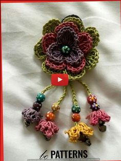 a crocheted flower with beads is shown on the cover of a video game