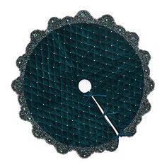 a clock that is on the side of a wall with beads and sequins