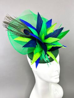 Emerald green, linen fascinator adorned with shades of navy and royal blue, lime and emerald green feathers. Attaches with interchangeable headband or hair clip option. Can be worn on the left or right side. Light and comfortable to wear. Prior to purchase, please note that all sales are final. Don't forget to check us out on Instagram @TheHatHive. Green Headband Mini Hat For Kentucky Derby, Green Mini Hat Headband For Kentucky Derby, Green Headband Hat For Kentucky Derby, Green Spring Headband, Green Feathered Fascinator For Kentucky Derby, Green Headband For Spring, Adjustable Green Headpiece For Royal Ascot, Summer Green Feathered Headpiece, Green Feathered Mini Hat For Royal Ascot