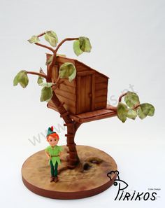 a small figurine is standing next to a tree house