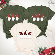 Embrace the whimsical charm of the season with our Santa Gnome Winter Christmas Shirt! Featuring delightful gnomes donning their plaid Santa hats, this tee encapsulates the essence of festive cheer and winter wonder. Perfect for a cozy gathering or a joyful holiday party, this tee adds a touch of playful elegance to your winter wardrobe. Its charming design and soft fabric make it an ideal choice for celebrating the magic of the holidays. Share the spirit of the season with our Christmas Gnomes Cozy Gathering, Gnomes Christmas, Santa Gnome, Santa Hats, Christmas Gnomes, Unique Boutique, Winter Vacation, Winter Wonder, Christmas Tees