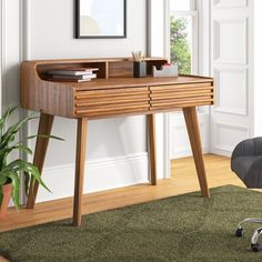 a wooden desk sitting in the corner of a room next to a chair and potted plant