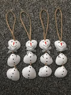 six snowmen ornament hanging from string on carpet