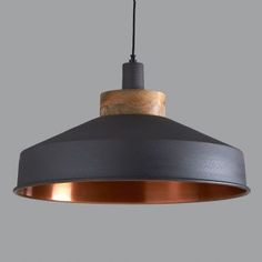 an industrial style pendant light hanging from a ceiling fixture with wood accents and metal fittings