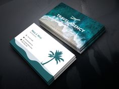 two business cards with palm trees and the words travel emergency on them are sitting on a table