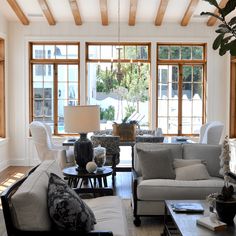 a living room filled with furniture and lots of windows