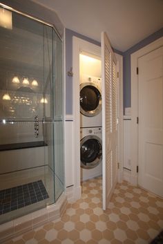 a washer and dryer in a bathroom next to each other