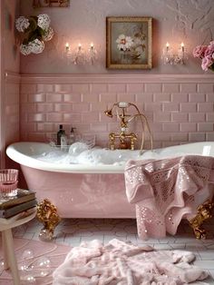 a bathroom with pink walls and white tile flooring, an antique claw foot bathtub in the center