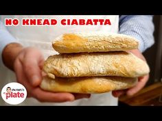 there is a person holding some bread in their hands with the words no knead ciabatta on it