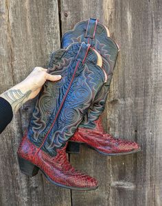 A*M*A*Z*I*N*G python leather cowboy boots, 1970s vintage. Features a bold red snakeskin foot, black leather embroidered body, cool scalloped leg openings, a low stacked heel, and lots of outlaw rocker style! Would look perfect statement casual with jeans and a t shirt, or all out Rodeo Queen with a fringe satin Pearl Snap...;) Brand : Justin Made in the USA Labeled size 6 B Unfortunately, these boots have not escaped the years unscathed...there is a fair amount of general wear & tear, including Fitted Red Boots For Rodeo, Traditional Fitted Boots For Rodeo, Red Fitted Boots For Rodeo, Vintage Leather Boots For Rodeo, Snake Cowboy Boots, Luxury Vintage Cowboy Boots With Reinforced Heel, Western Snip Toe Boots With Snake Print, Western Vintage Brown Boots For Rodeo, Snakeskin Cowboy Boots