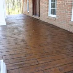 a wooden floor in front of a brick building