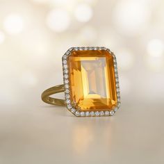 This stunning ring features an emerald-cut 11.35-carat citrine with beautiful saturation. The center stone is surrounded by a halo of diamonds. This ring is 18k yellow gold and decorated with a floral-motif openwork under-gallery.  ✦ GEMSTONE SPECIFICATIONS:    Center Gemstone: Citrine  Gemstone Cut: Emerald Cut  Gemstone Weight: Approx 11.35 Carats  ✦  RING SPECIFICATIONS:    Material: 18k Yellow Gold  Stones: Citrine and Diamond      ✦ WHAT COMES IN YOUR SHIPMENT:    - Your Ring  - Quality Rin Ring With Halo, Estate Diamond Jewelry, Citrine Ring, 18k Yellow Gold Ring, Natural Citrine, Citrine Gemstone, Yellow Gold Ring, Ring Box, Halo Diamond