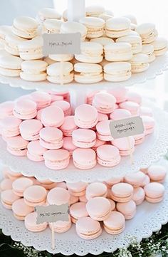 three tiered trays filled with pink and white macaroons