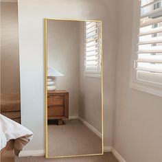 a large mirror in the corner of a room