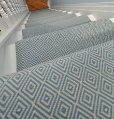 the stairs in this house are decorated with blue and white carpet