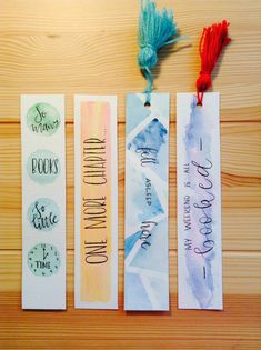 three bookmarks with writing on them and tassels attached to each one's sides