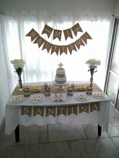 a table topped with cake and desserts next to a window